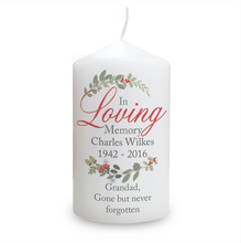 Load image into Gallery viewer, This personalised pillar candle bears the sentiment In Loving Memory and has a holly, fir cone, oak and acorn wreath motif. The red and green colours make this particularly lovely as a Christmas memorial candle.